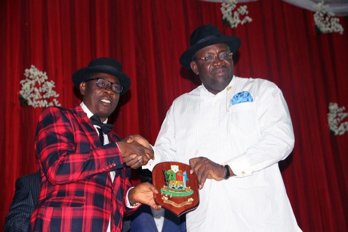 Bayelsa State Governor, Hon. Seriake Dickson (R), presents a special souvenir to the Speaker, Bayelsa State House of Assembly, Rt. Hon. Konbowei Benson, during a state dinner in honour of the 5th Assembly of the State House of Assembly, at the Chief DSP Alamieyeseigha Memorial banquet hall, Government House, Yenagoa.